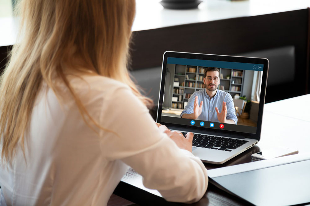 over shoulder view of therapist on computer 