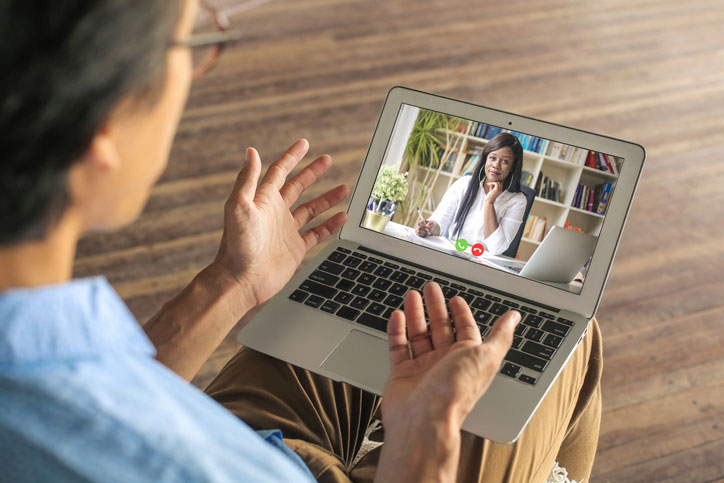 man talks with therapist virtually