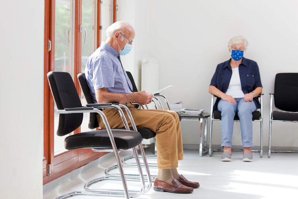 man wears mask in doctor's office