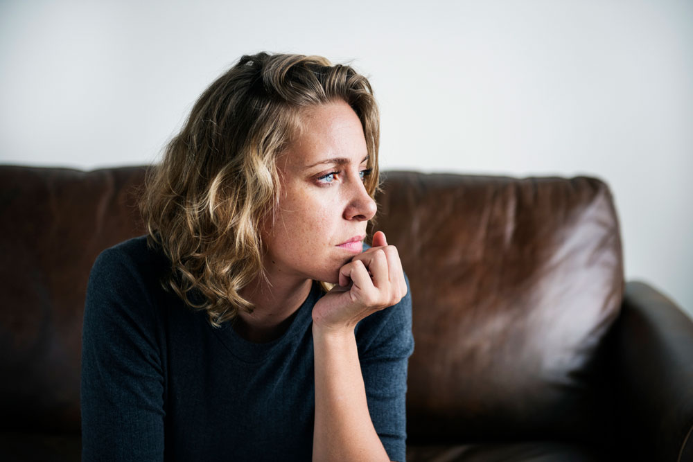 woman looks out window