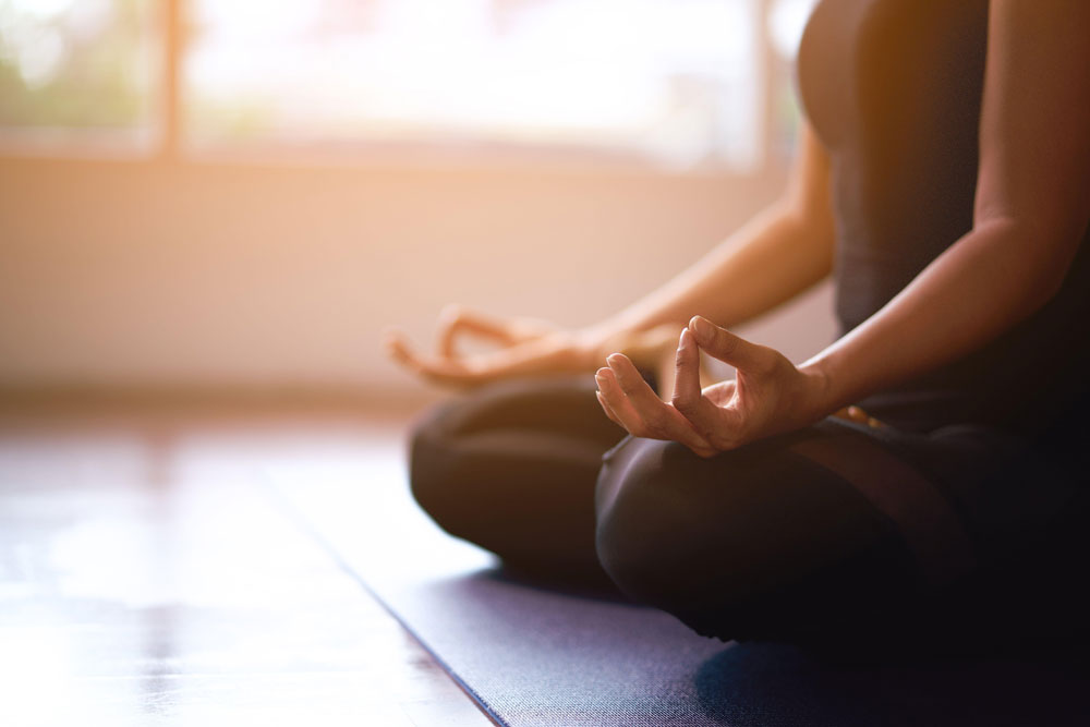 Woman meditating in sunshine