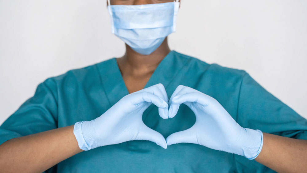 nurse holding hands in heart