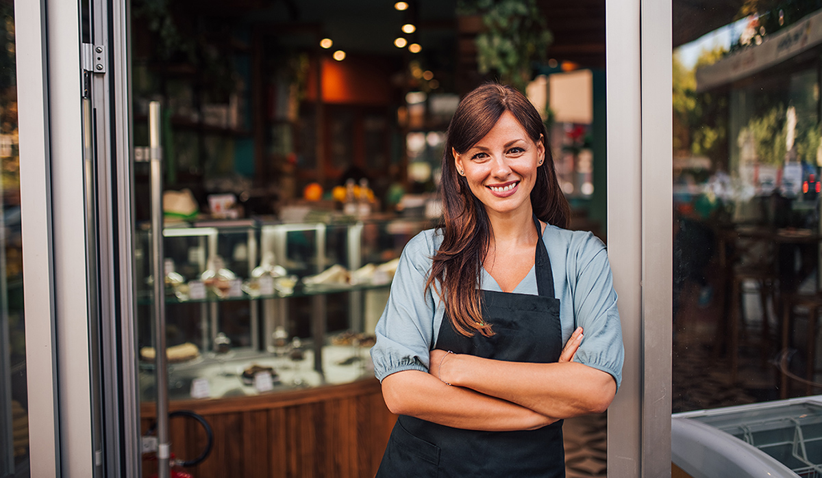 woman standing in front of bakery